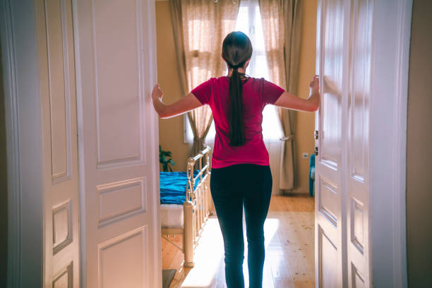 istock Woman opening door 1304099251