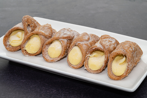 Cannoli with a Sicilian lemon cream filling on a white plate