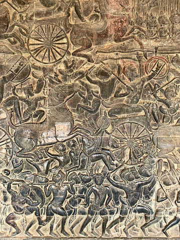 Angkor Wat, Cambodia - January 22, 2020: Bas reliefs from the western part of the third enclosure galleries of Angkor Wat temple. The Angkor Wat is a Hindu temple complex in Cambodia and is the largest religious monument in the world.