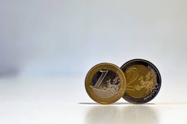 istock 1 and 2 euro close up on blurred background 1304102472