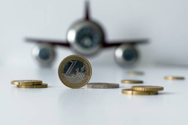 istock 1 euro coin on blurred watch like plane 1304102473