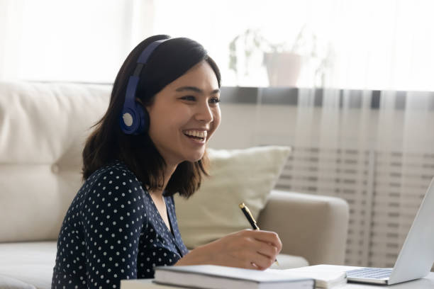 istock Happy millennial vietnamese asian woman enjoying distant e-learning. 1304102572