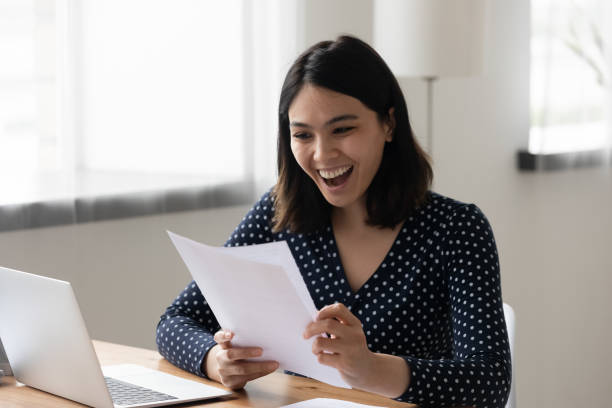 istock Euphoric smiling young mixed race worker getting job promotion letter. 1304102635