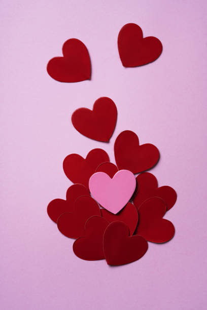 istock Pink and red hearts over a pink background. 1304103655