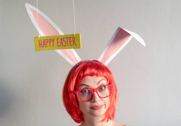 istock Woman with white rabbit ears on Easter day 1304104798