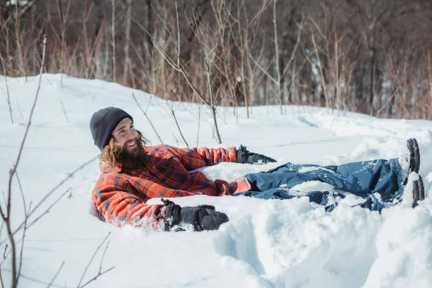 istock Young man lying down in the snow 1304104947