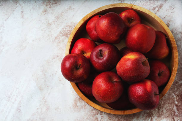 Ripe apples Starking in the wooden bowl stock photo