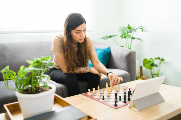 istock Hispanic woman having a good time playing chess online 1304112895