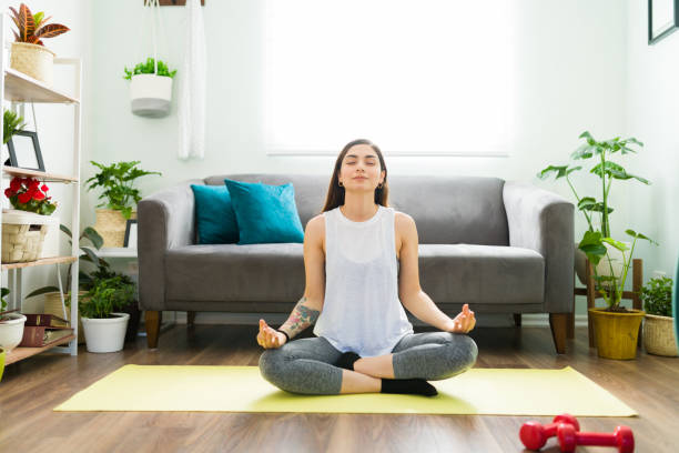 istock Hispanic woman meditating at home and feeling relaxed 1304114861