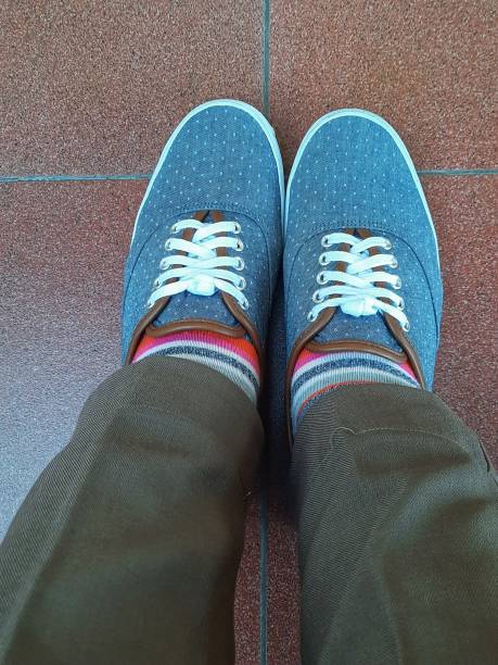 istock Blue shoes with rainbow socks and brown pants 1304114898