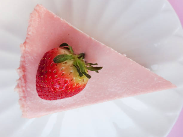 Strawberrie cheececake isolated on pastel pink background