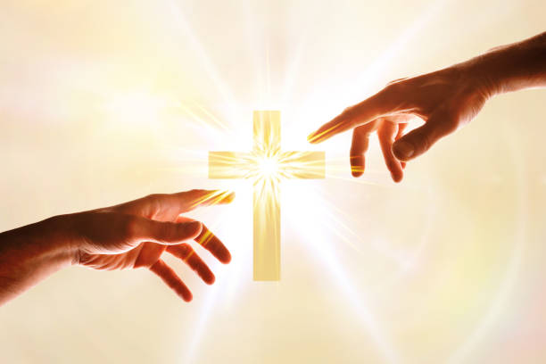 Hands wanting to touch a cross with flash of light
