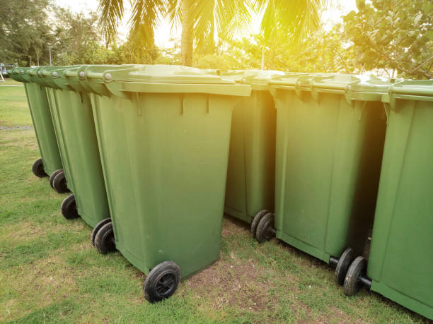 istock A row of green dustbin with sun flare.Pollution concept. 1304117246