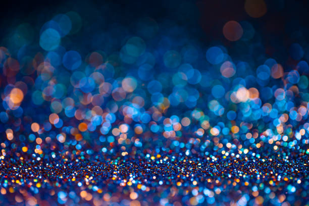 istock Festive twinkle glitters background, abstract sparkle backdrop with circles,modern design overlay with sparkling glimmers. Black, blue and golden backdrop glittering sparks with blur effect. 1304120099
