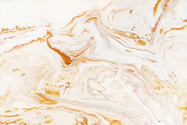 Caramel dynamic and fluid raster texture. Abstract acrylic paints mixt color background. Dyeing, liquid flow surface modern design. Orange and white contrast pigments, watercolor wallpaper