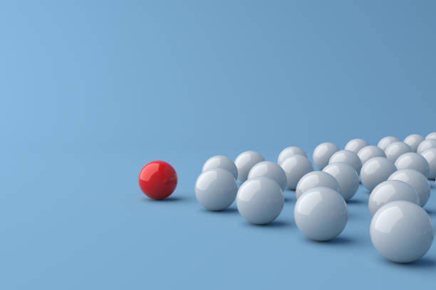 istock Leadership concept, red leader ball leading white balls, on blue background with empty copy space 1304121012