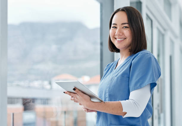 All I need can be accessed with such ease Portrait of a medical practitioner using a digital tablet in a hospital female nurse stock pictures, royalty-free photos & images