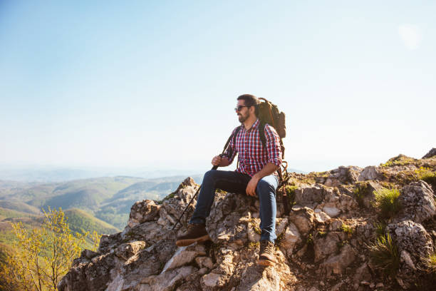 istock Man traveling with backpack hiking in mountains 1304126737