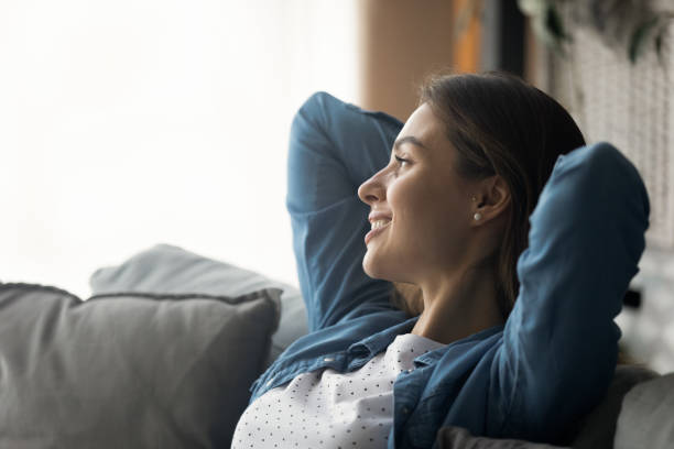 istock Serene millennial woman relax on sofa with hands over head 1304127013