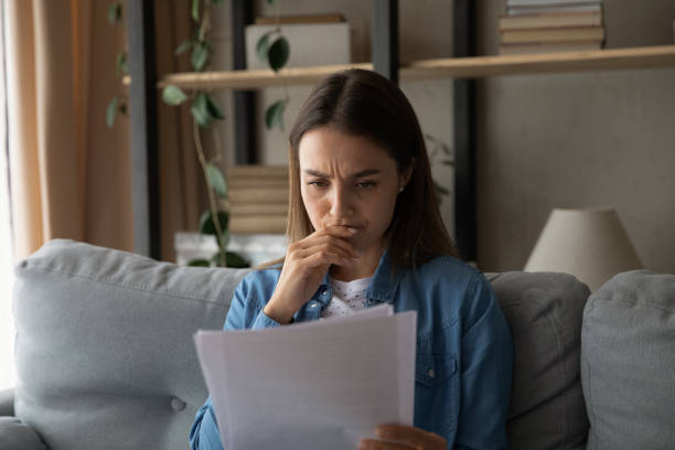 istock Stressed female student reading letter of being expelled from university 1304127030