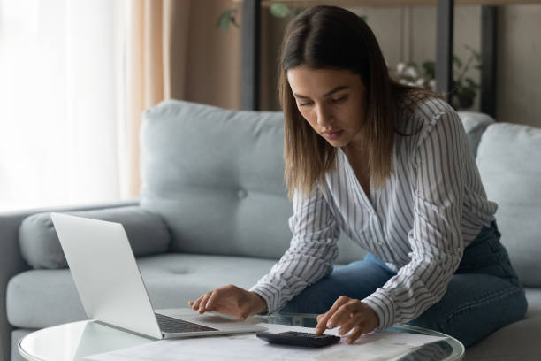 istock Female student planning to pay college loan count payment sum 1304127554