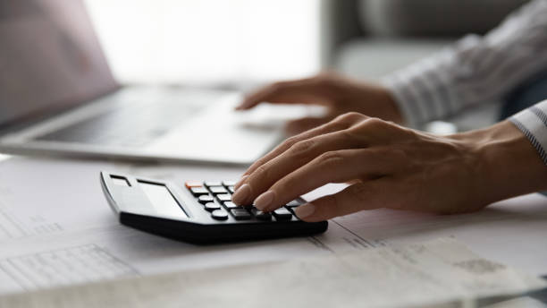 istock Cropped view of young woman doing paperwork manage financial documents 1304127563