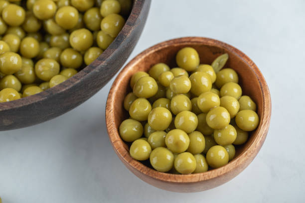 istock Two bowl full with marinated green olives on white background 1304127691