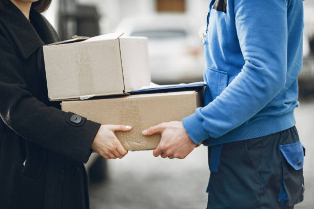 istock Man gives a parcel to a female client 1304133081