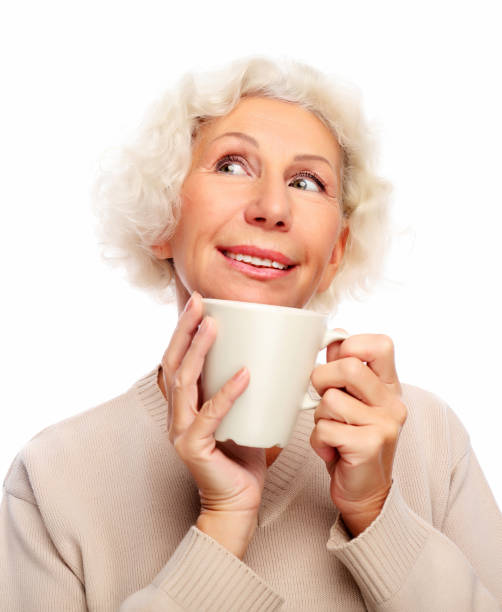 istock old excited lady smiling laughing, holding cup drinking coffee or tea 1304134206