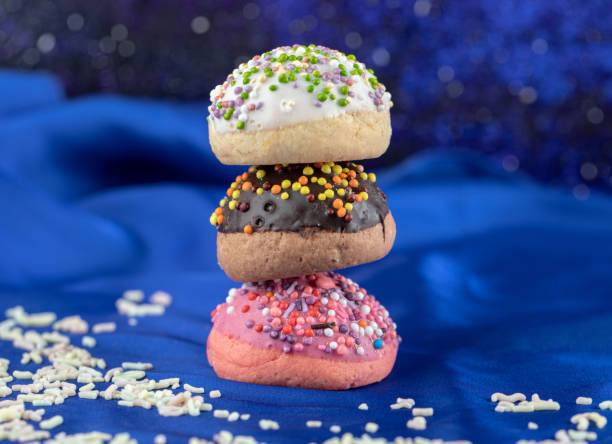 istock Three cookies with sprinkles on blue cloth 1304135983