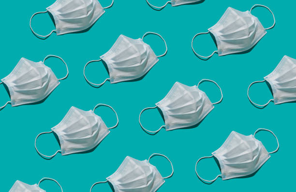 istock surgical medical face mask repetition pattern with trendy lighting with hard shadow 1304137653