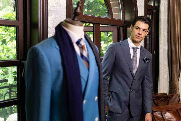 istock Handsome man in elegant classic suit, tailor store. 1304138530
