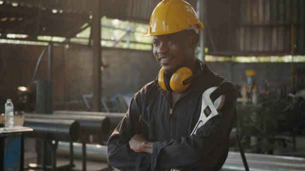 istock Engineer standing holding wrench tools and arms crossed at work in the industry 1304141564