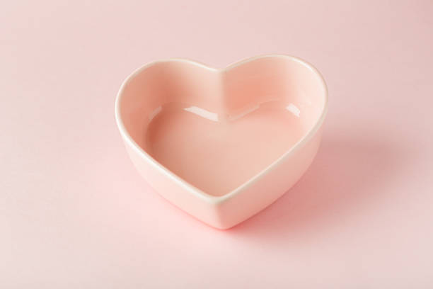 istock Empty pink plate in the shape of a heart on a pink background 1304143202