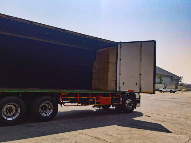 istock Worker driving forklift loading shipment carton boxes goods on wooden pallet at loading dock from container truck to warehouse cargo storage in freight logistics, transportation industrial, delivery 1304145634