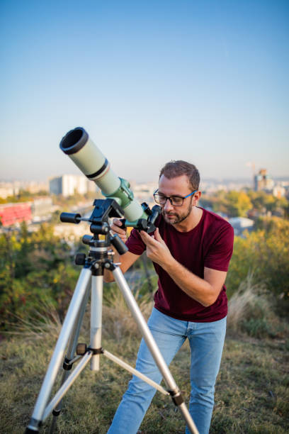 istock Amateur astronomer looking at the sky with a telescope. 1304149810