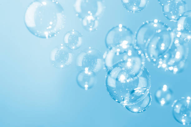 istock Beautiful shiny transparent blue soap bubbles background. 1304150953