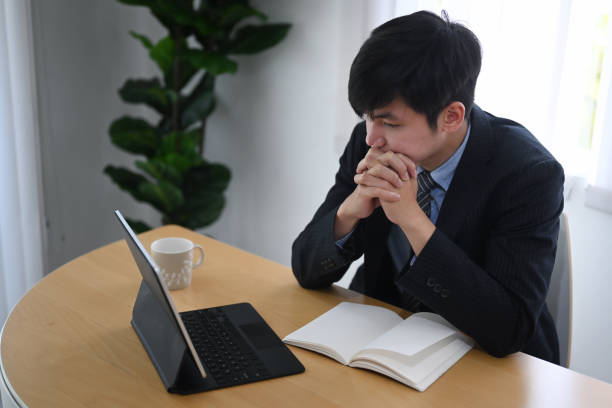istock Serious businessman looking at computer tablet while sitting at his working place. 1304155880