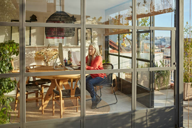 istock Mid 60s Businesswoman Telecommuting from Home Office 1304157530