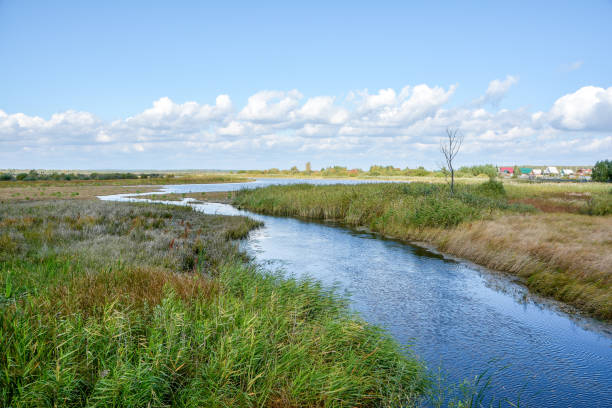 istock summer landscape of blue river and sky with clouds 1304158443