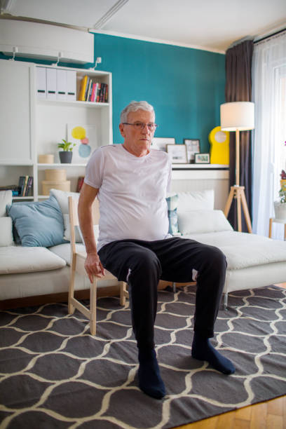 istock Senior Man Exercising At Home Without Traditional Equipment 1304159333