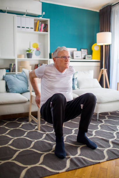 istock Senior Man Exercising At Home Without Traditional Equipment 1304159340