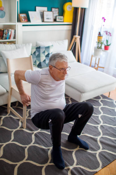 istock Senior Man Exercising At Home Without Traditional Equipment 1304159348