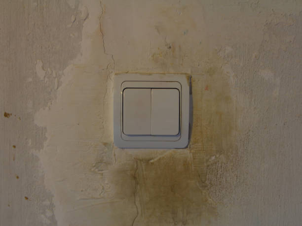 istock Dirty white light switch with dirty handprints on dirty white wall background 1304161432