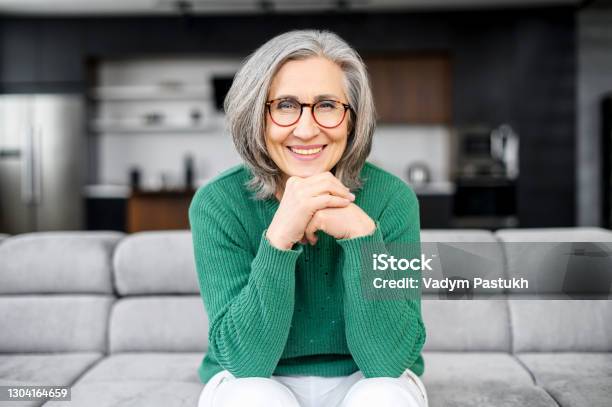Healthy Aged Woman Sitting On The Sofa Stock Photo - Download Image Now - One Woman Only, Senior Adult, Portrait