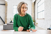 Aged healthy woman with pulse oximeter
