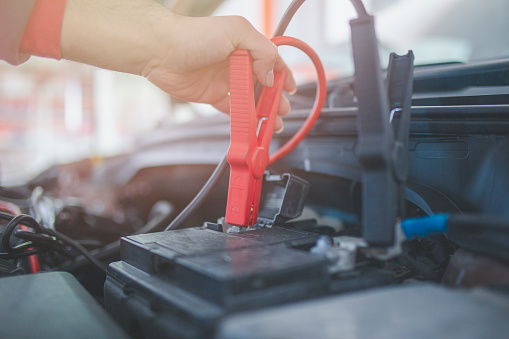 lose up Charging car battery with electricity trough jumper cables.