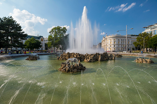 Vienna, Austria - August 28, 2019: Hochstrahlbrunnen is a beautiful water fountain on the town square Schwarzenbergplatz in Vienna, Austria.
