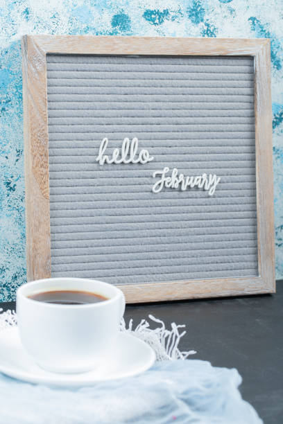 istock Hello february poster embedded on grey background with a cup of drink aside 1304167841