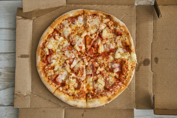 istock Pizza assorted pepperoni in box and on white plate. Hot with cheese and seafood. 1304167989